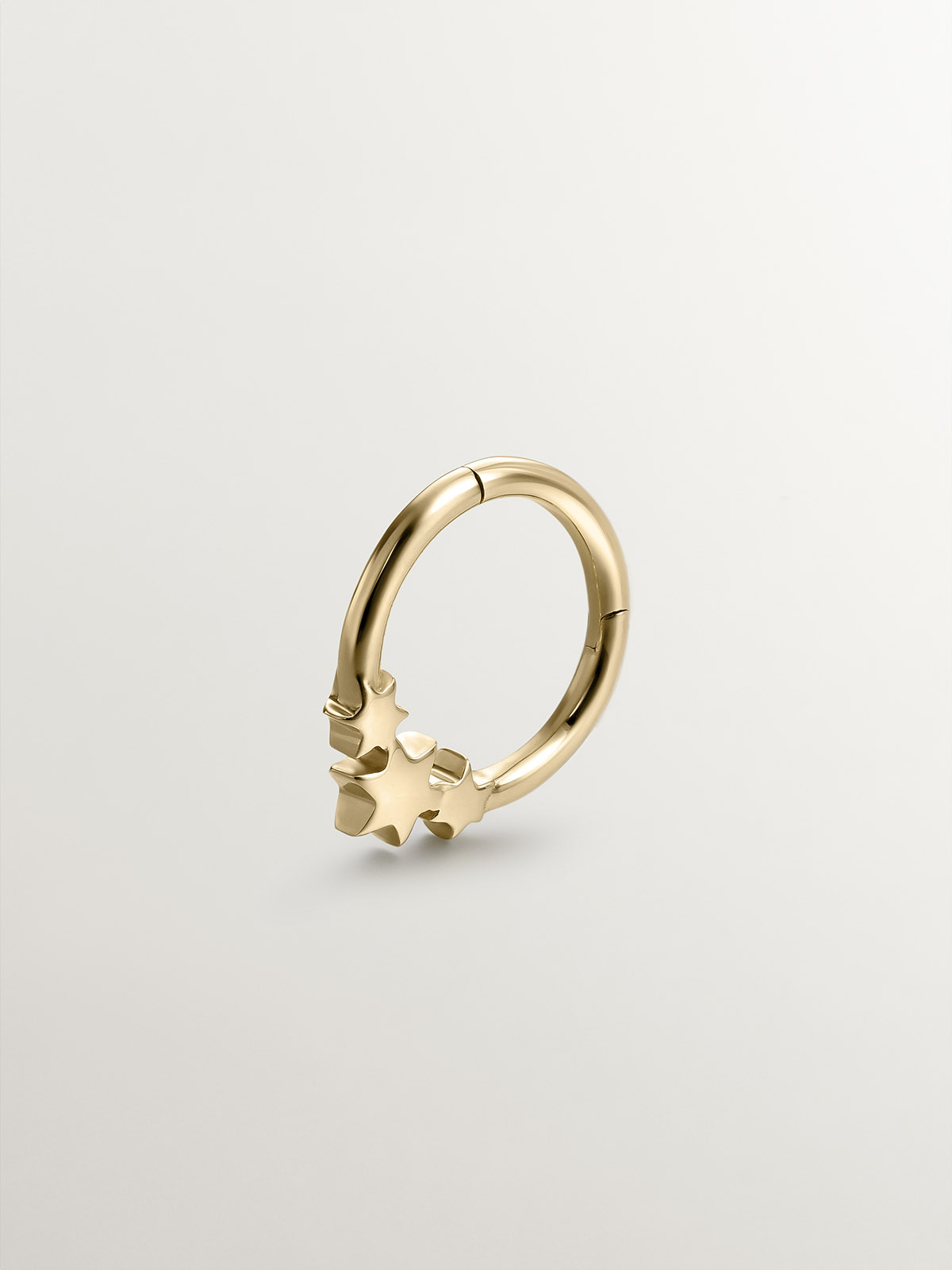 Small 9K yellow gold hoop earring with stars.