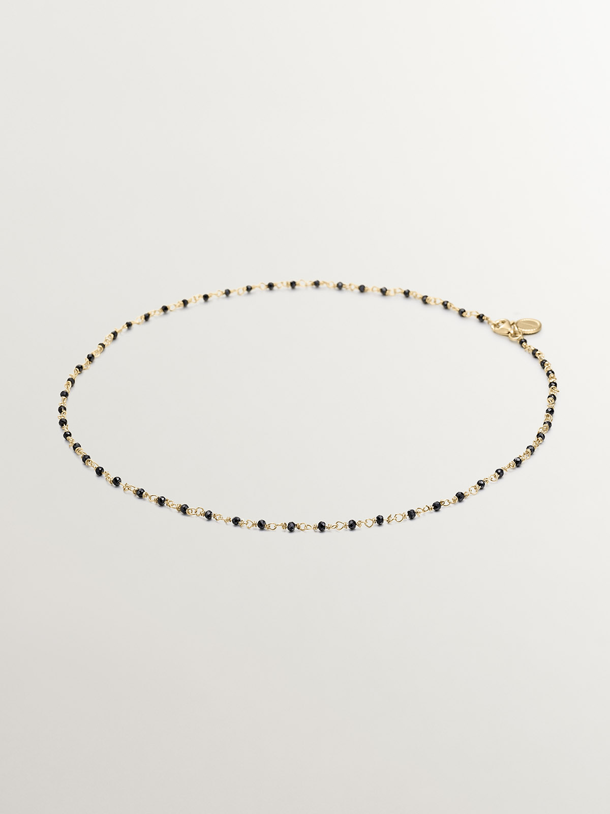 925 Silver chain plated in 18K yellow gold with black spinels.