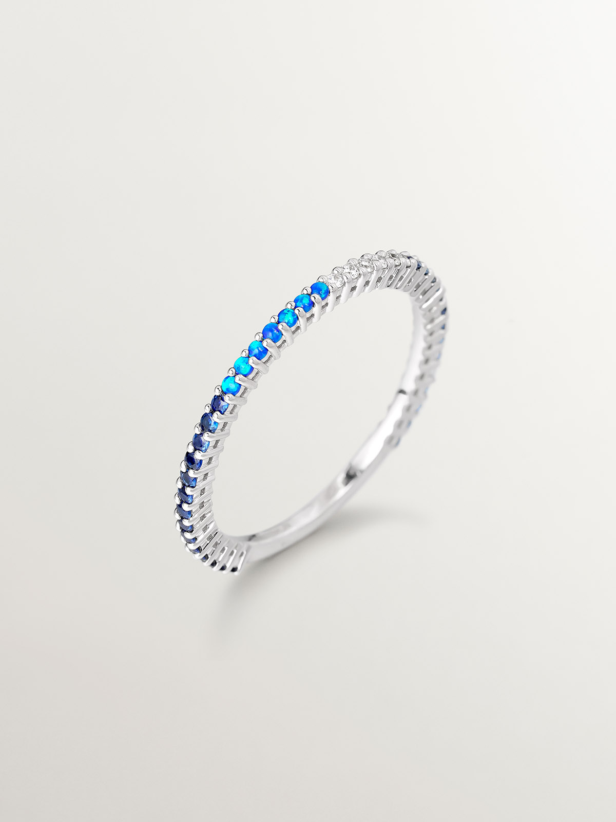 18K white gold ring with lab-grown blue opals, white diamonds, and blue sapphires.