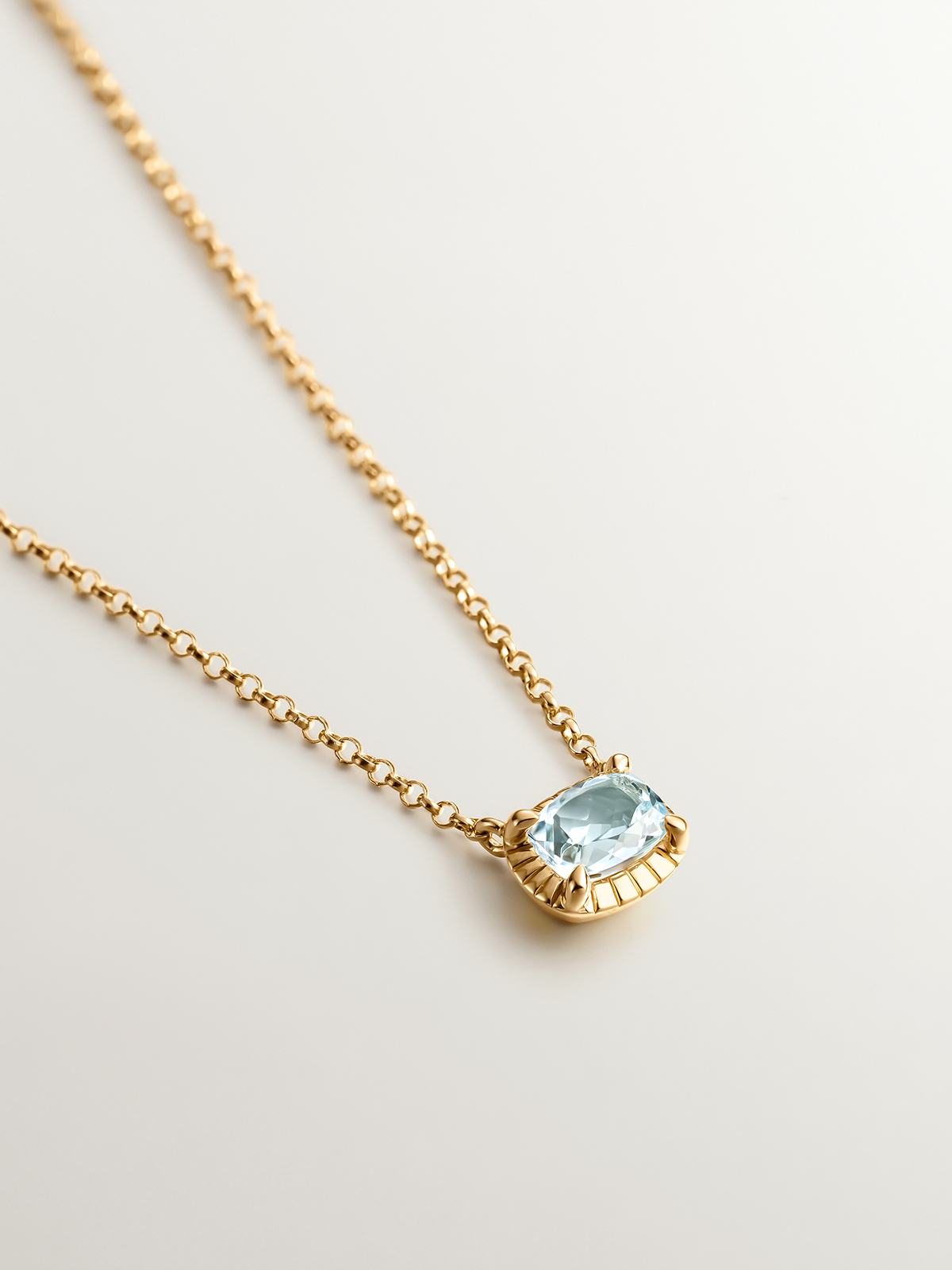925 Silver pendant bathed in 18K yellow gold with sky blue topaz.