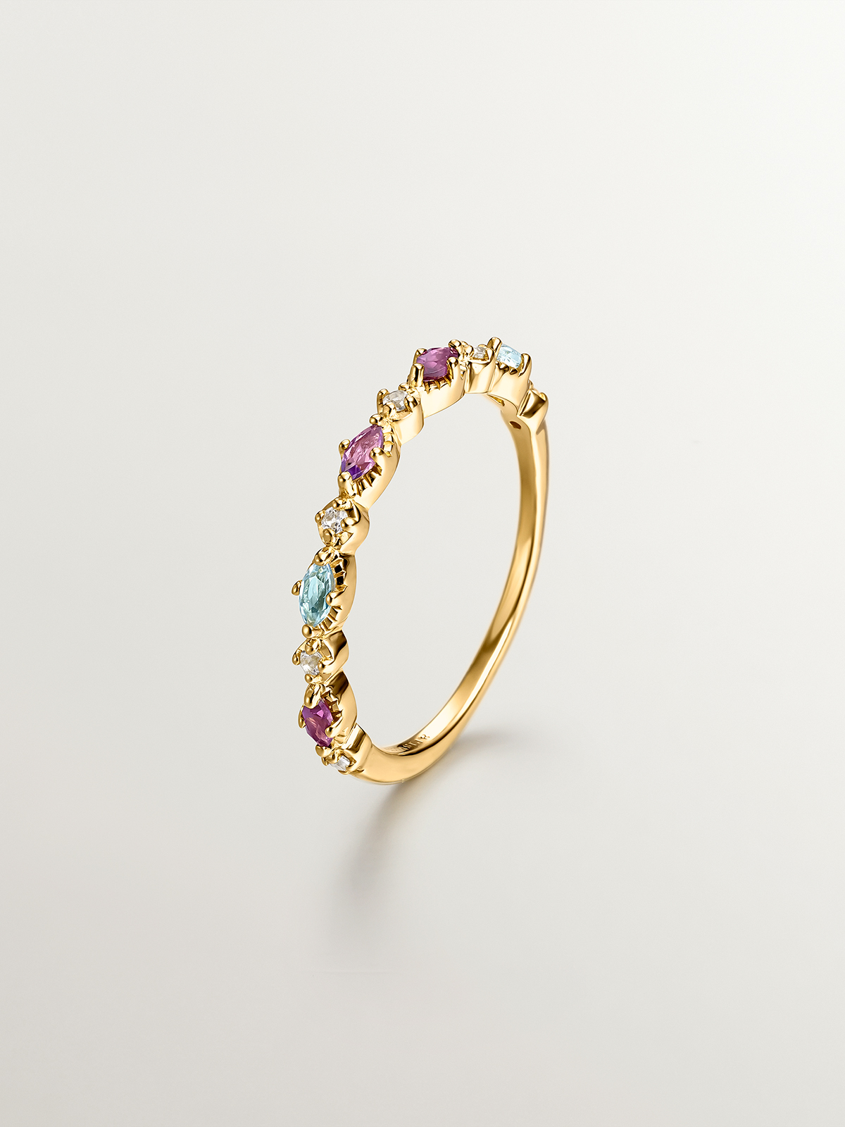 927 Silver ring bathed in 18K yellow gold with topaz, rhodolites, and amethyst.