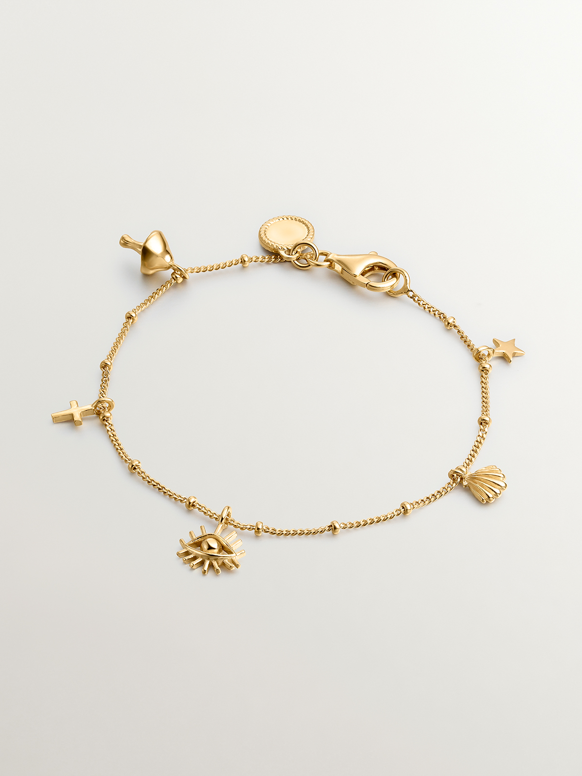 Pulsera de plata 925 bañada en oro amarillo de 18K con motivos de seta, cruz, ojo, concha y estrella