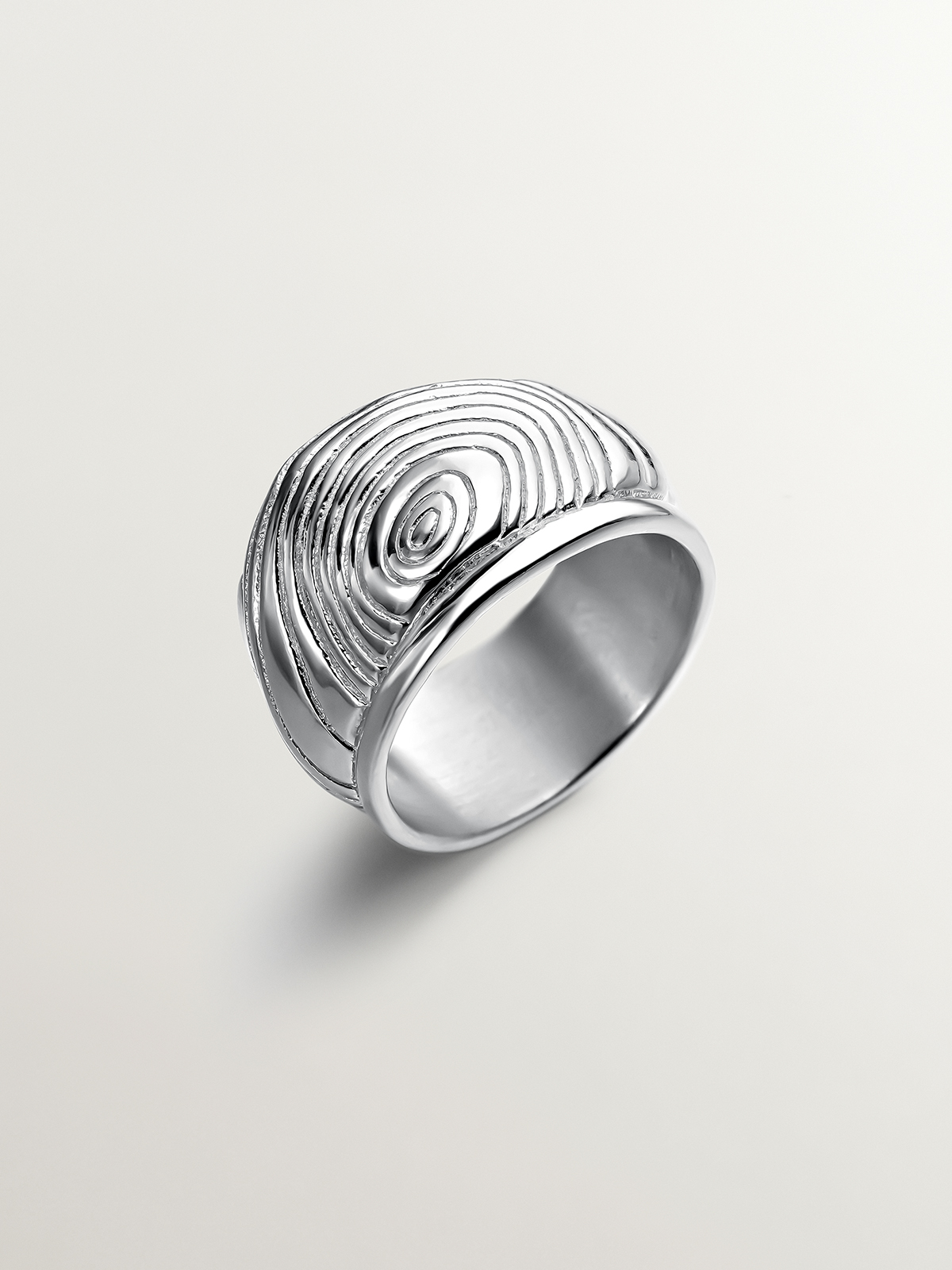 Wide 925 silver ring with embossing and irregular shape.