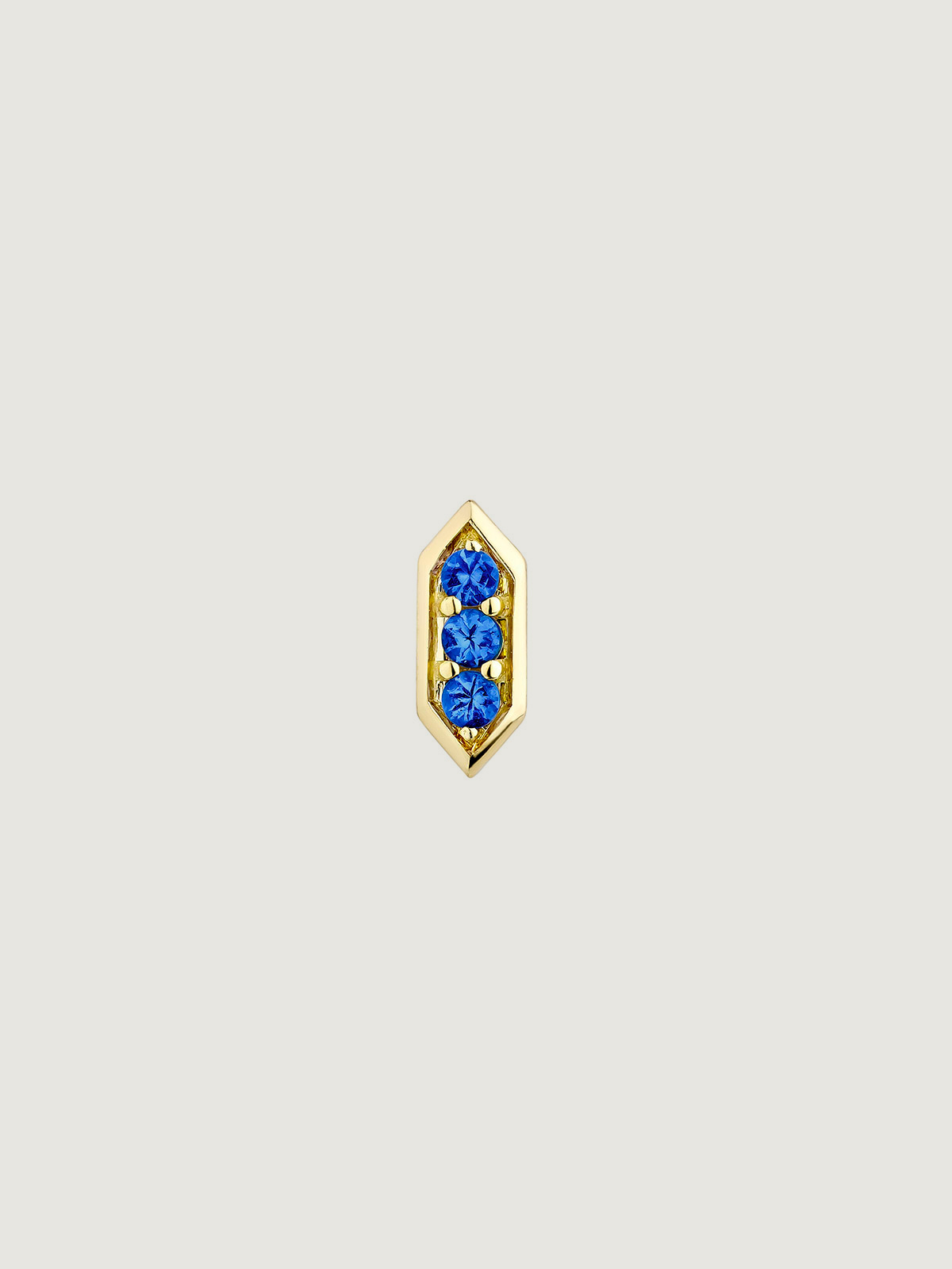 Hexagonal piercing of 18k yellow gold with blue sapphires