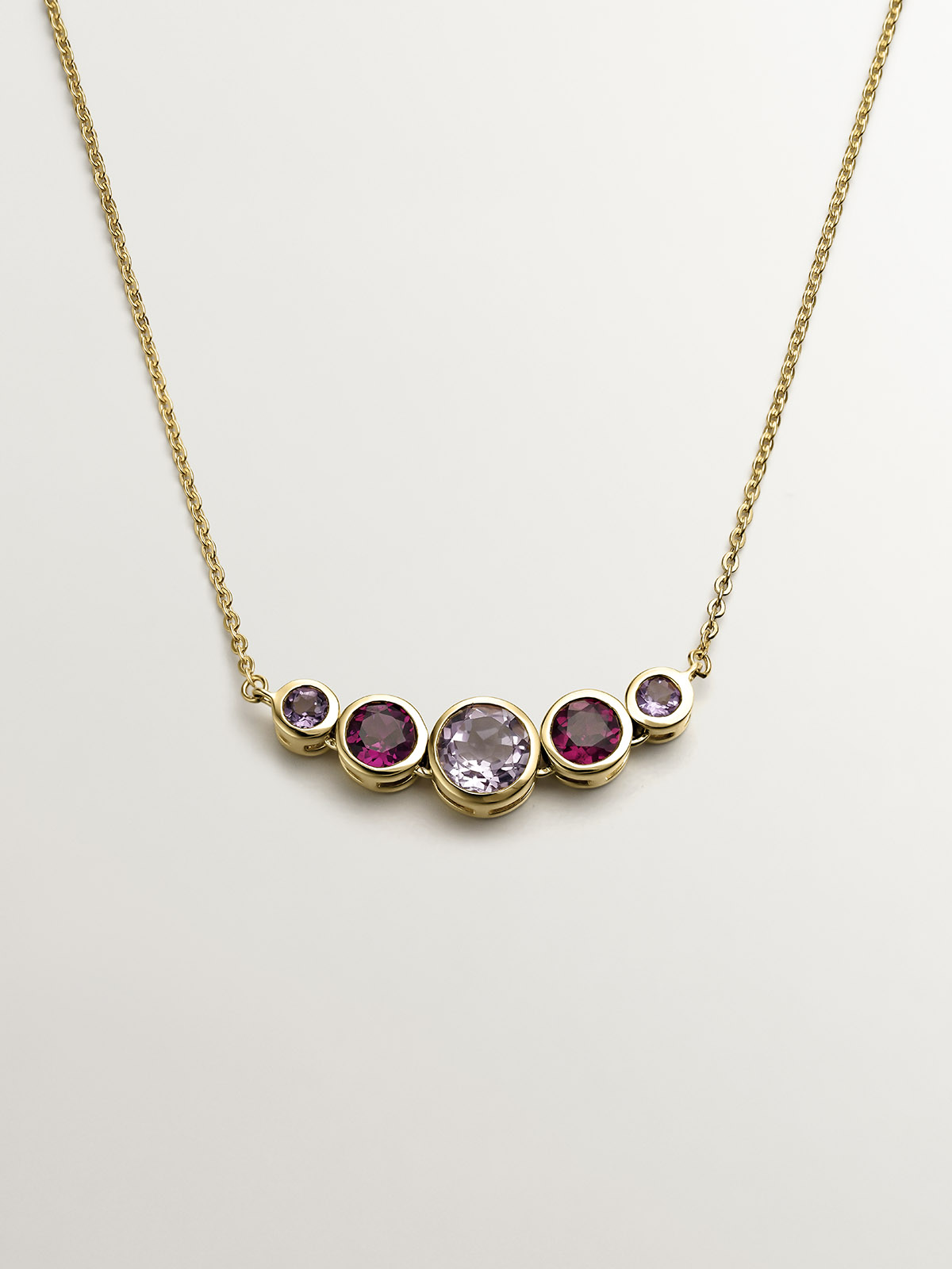 925 Silver pendant bathed in 18K yellow gold with pink rhodolites and purple amethysts.