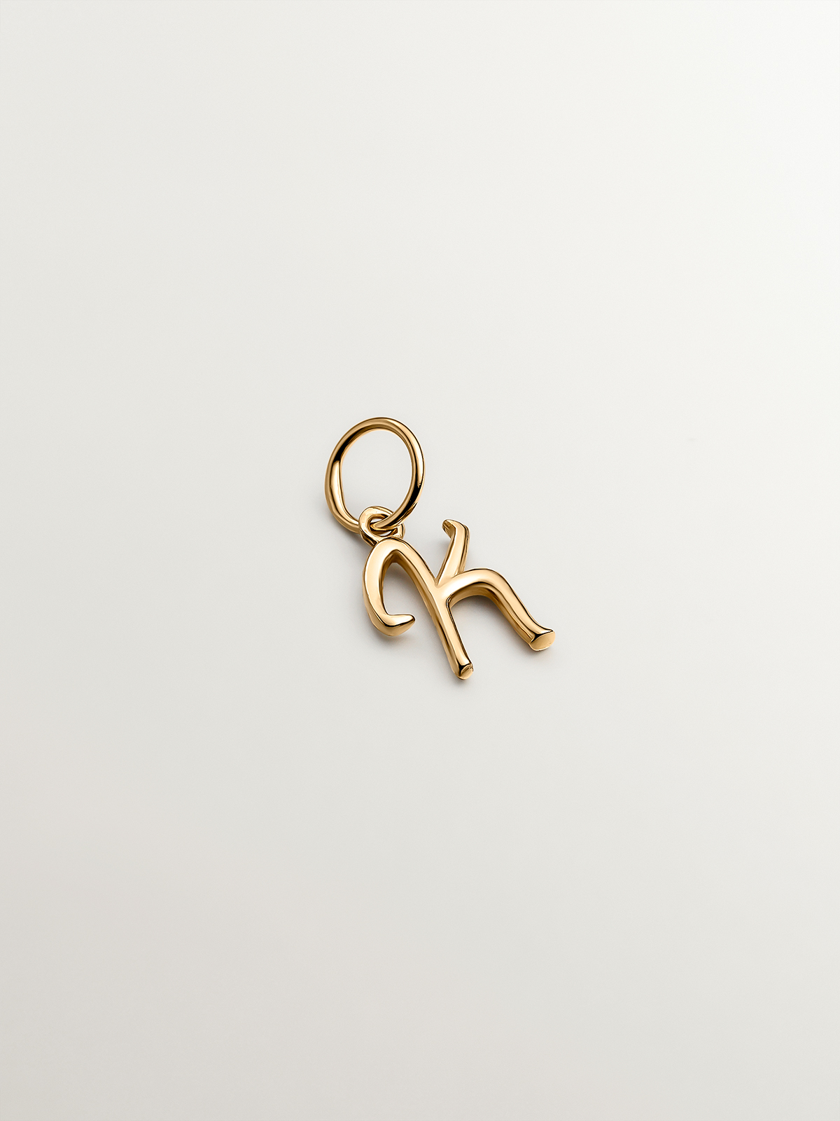 925 Silver charm bathed in 18K yellow gold with initial K.