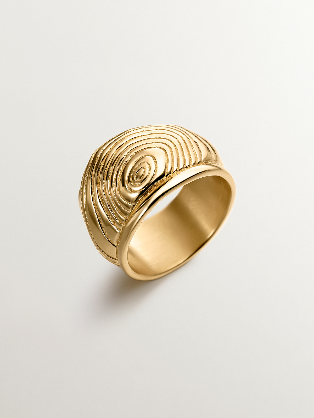 Wide 925 silver ring bathed in 18K yellow gold with embossed and irregular shape