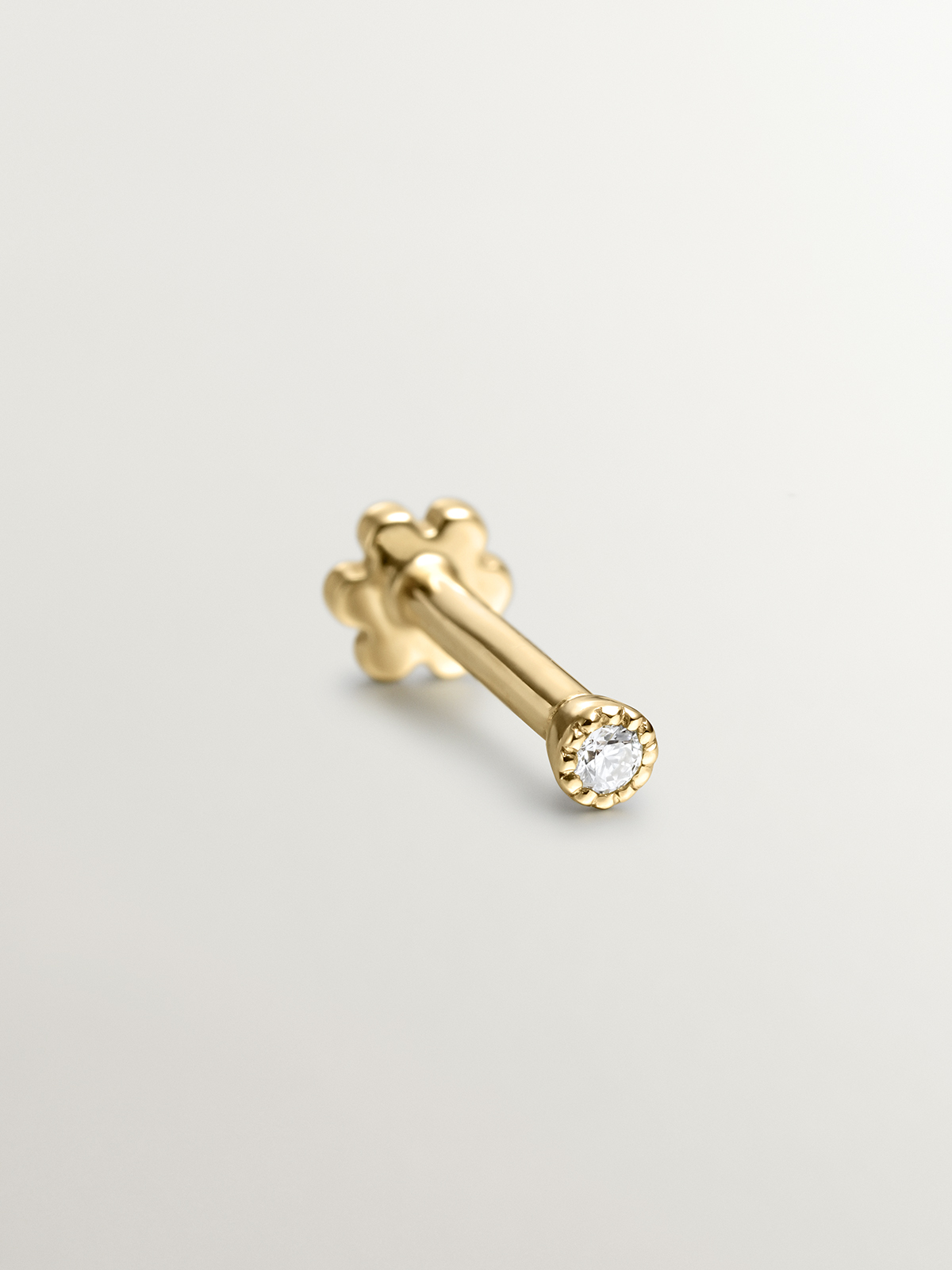 Individual 18K yellow gold piercing with diamond