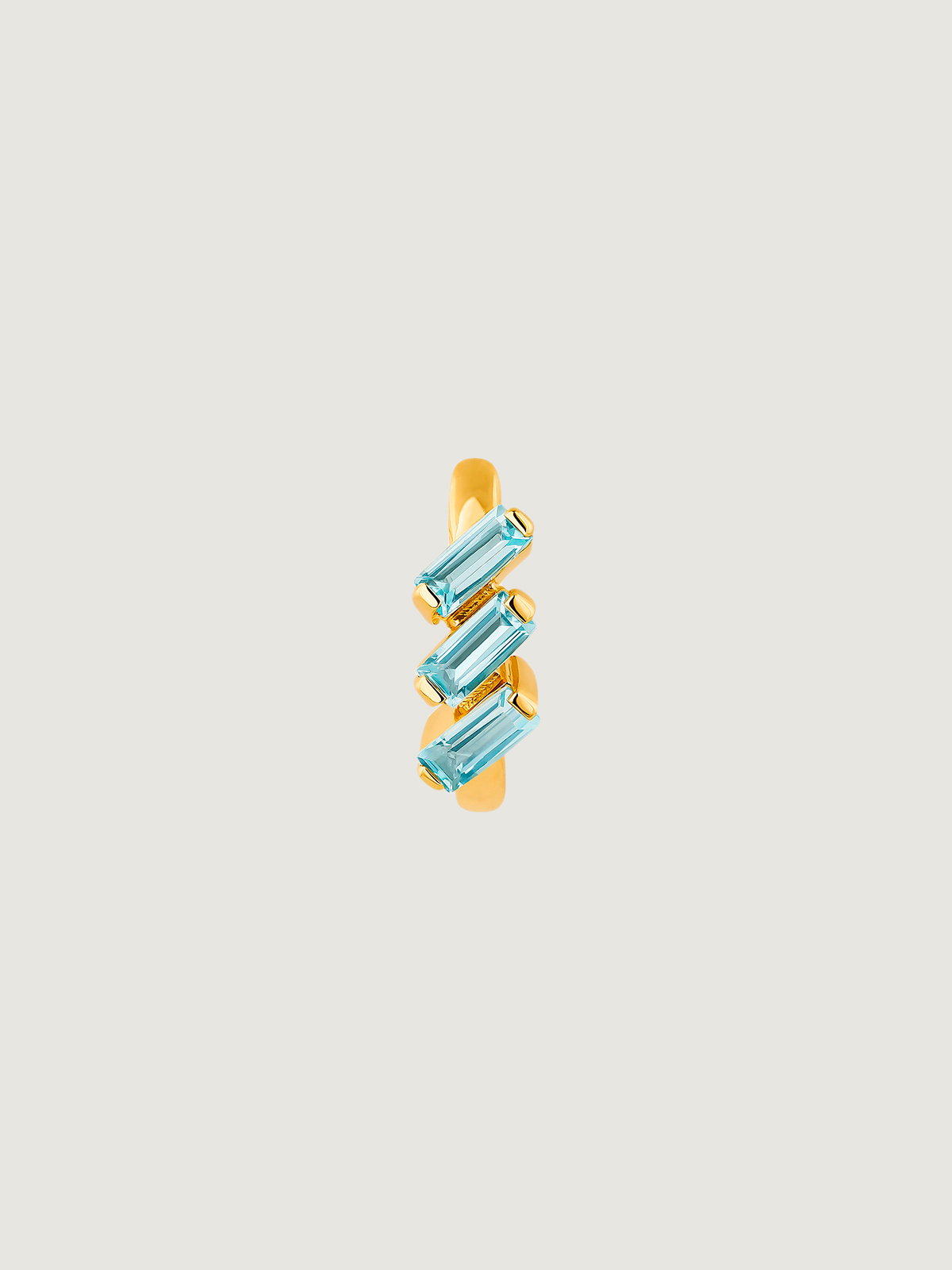 Individual hoop earring made of 925 silver, bathed in 18K yellow gold with sky blue topaz.