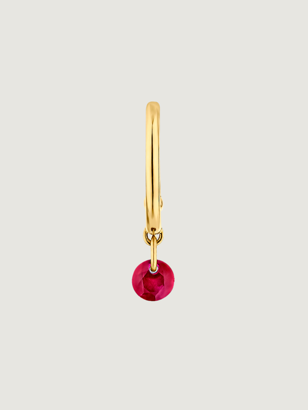 Individual 9K yellow gold hoop earring with ruby.