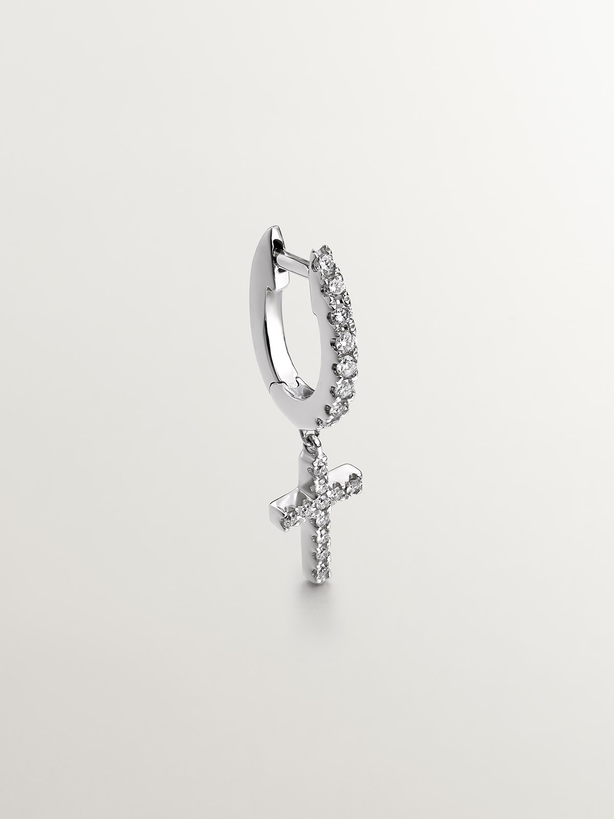 Single 18K white gold earring with diamonds and cross.