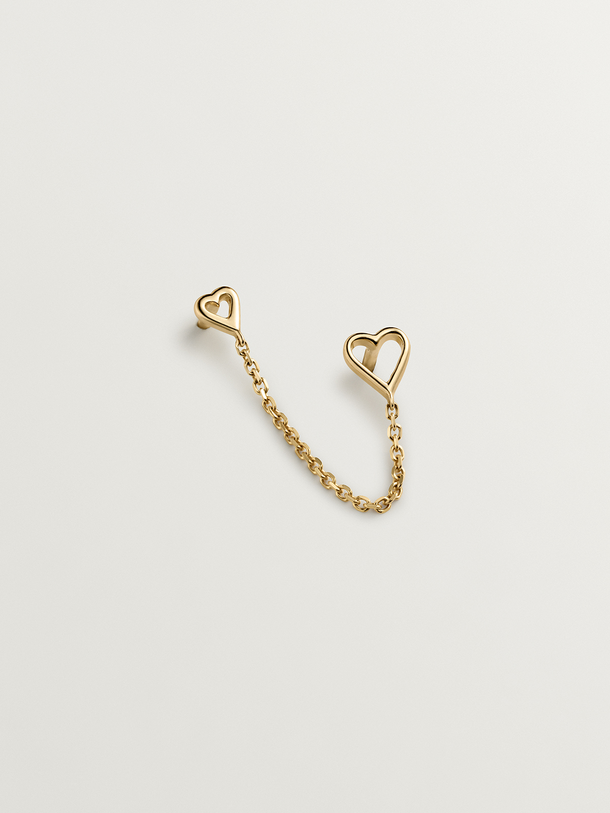 Individual 9K yellow gold climber earring with hearts.