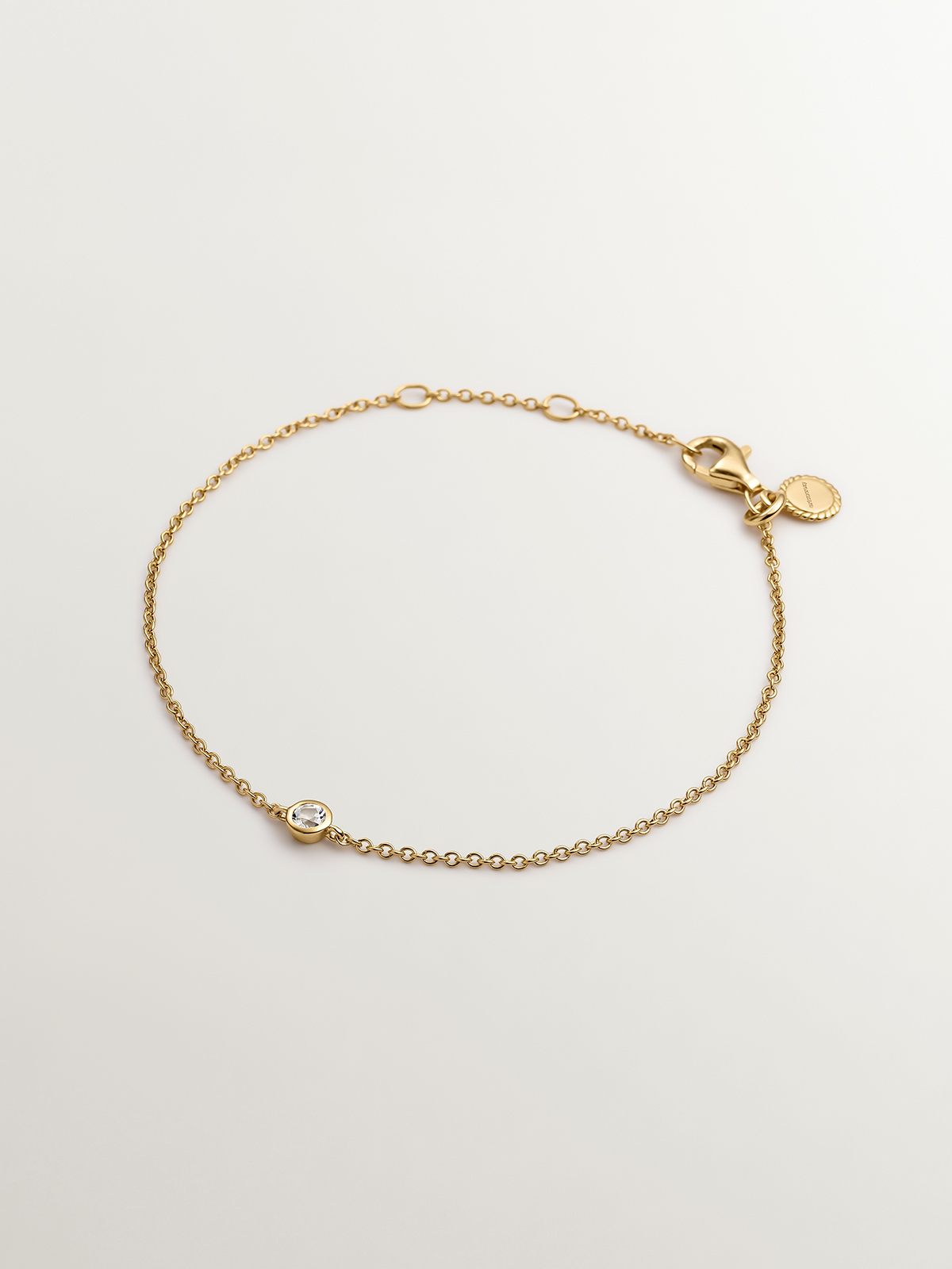 Pulsera solitario de plata 925 bañada en oro amarillo de 18K con topacio blanco