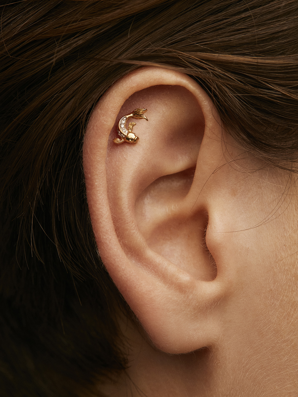 Individual 18K yellow gold earring with diamond-shaped fish.