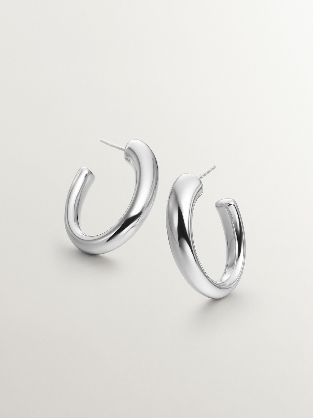 Large and thick 925 silver hoop earrings with an oval shape