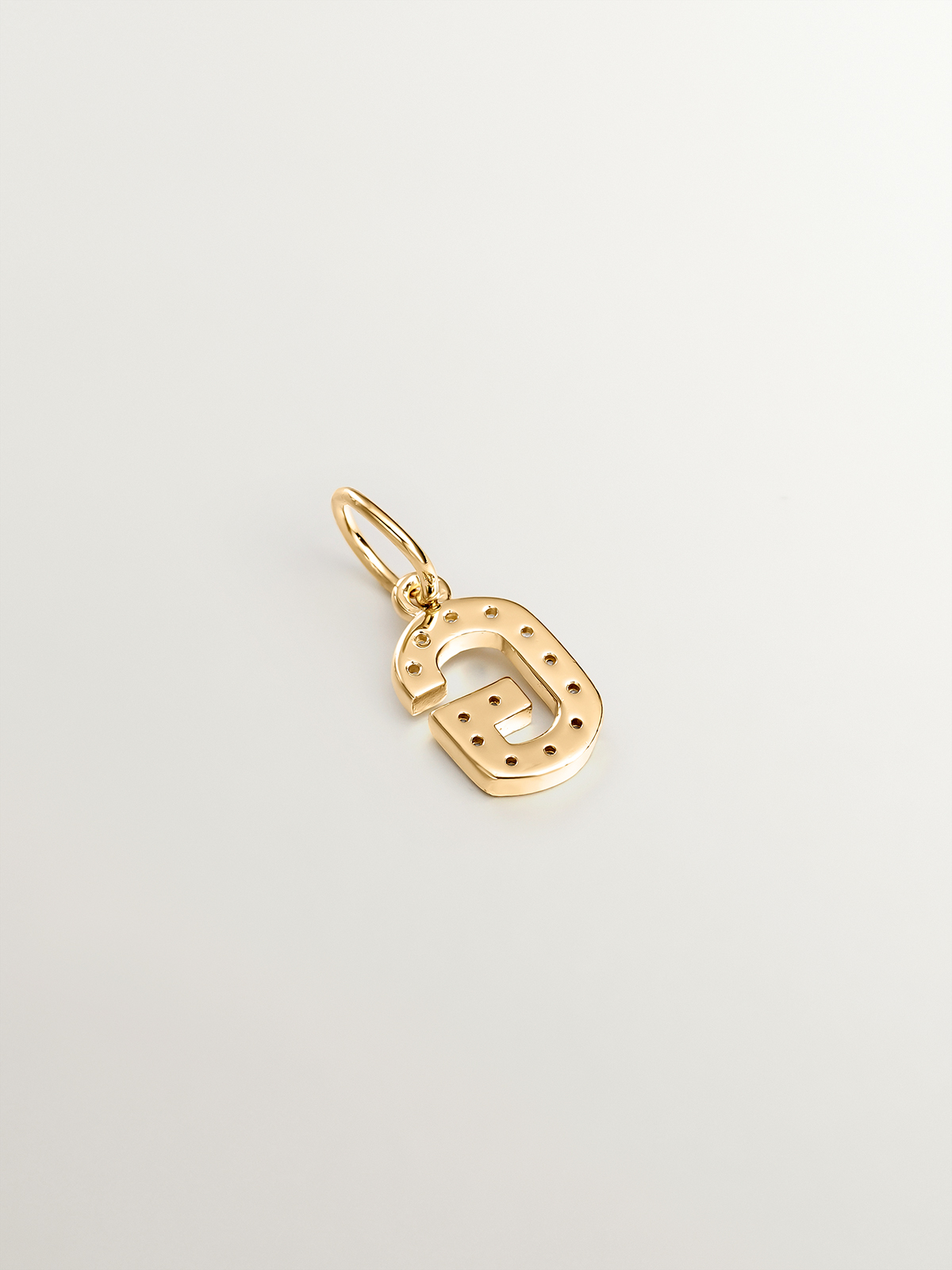 Charm made of 925 silver, bathed in 18K yellow gold and white topaz with the initial G.