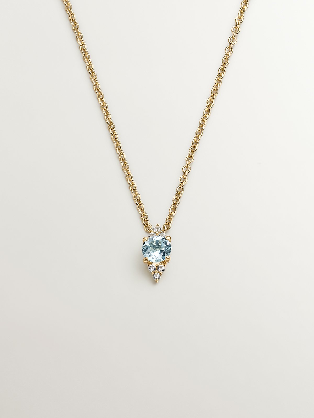 925 Silver pendant bathed in 18K yellow gold with sky blue topaz and white sapphires.